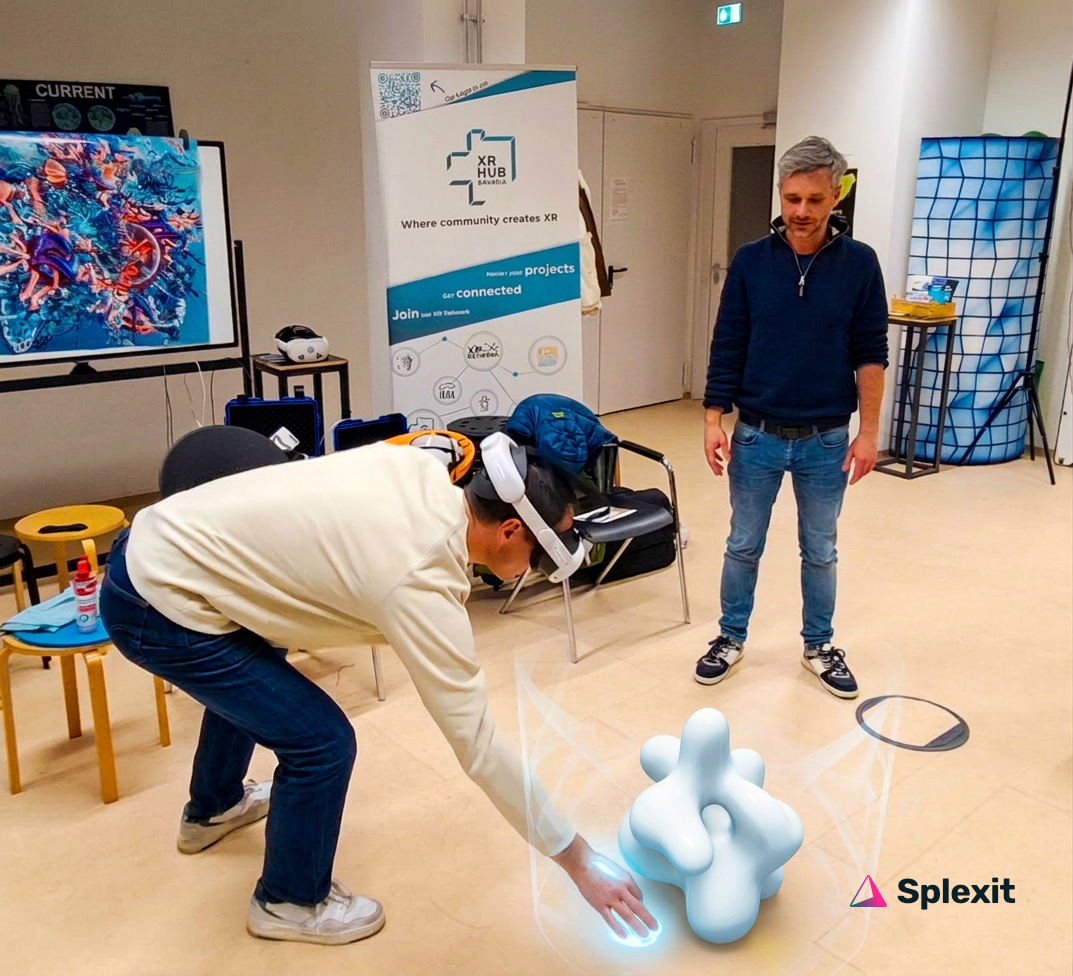 Teacher with VR headset interacting with a virtual 3D object in the room, workshop facilitator standing nearby